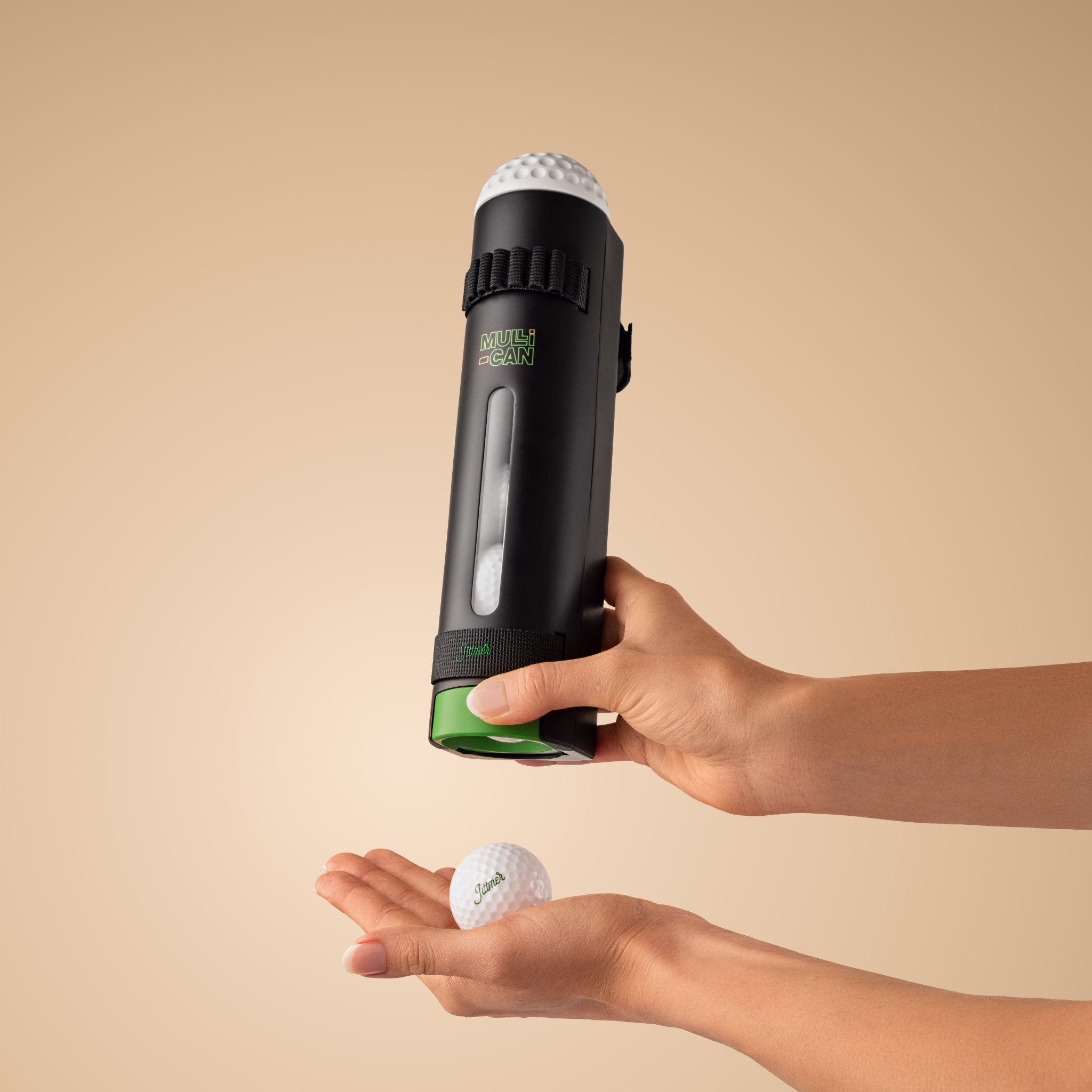 Hand pressing the Jittmer Mulli-Can to dispense a golf ball