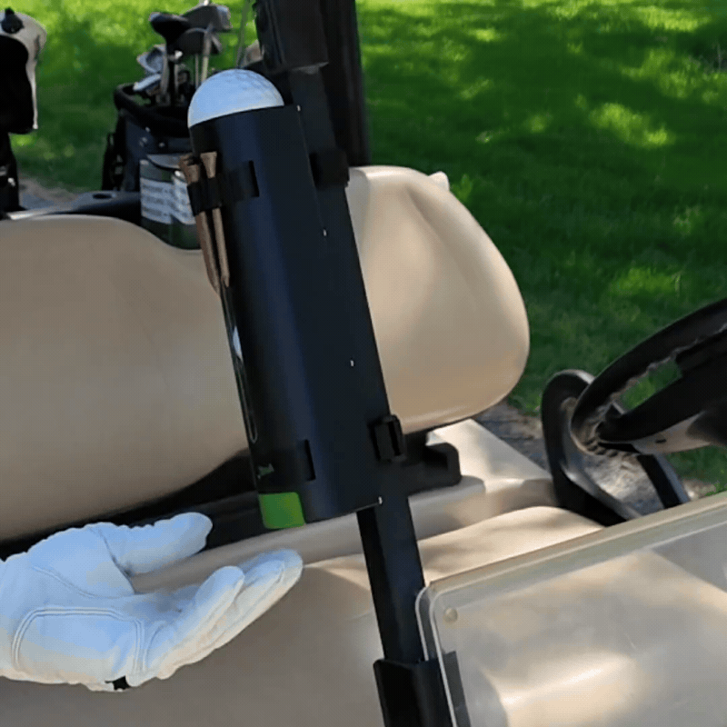 Pushing the Mulli-Can button to dispense a ball and removing a tee from tee loops